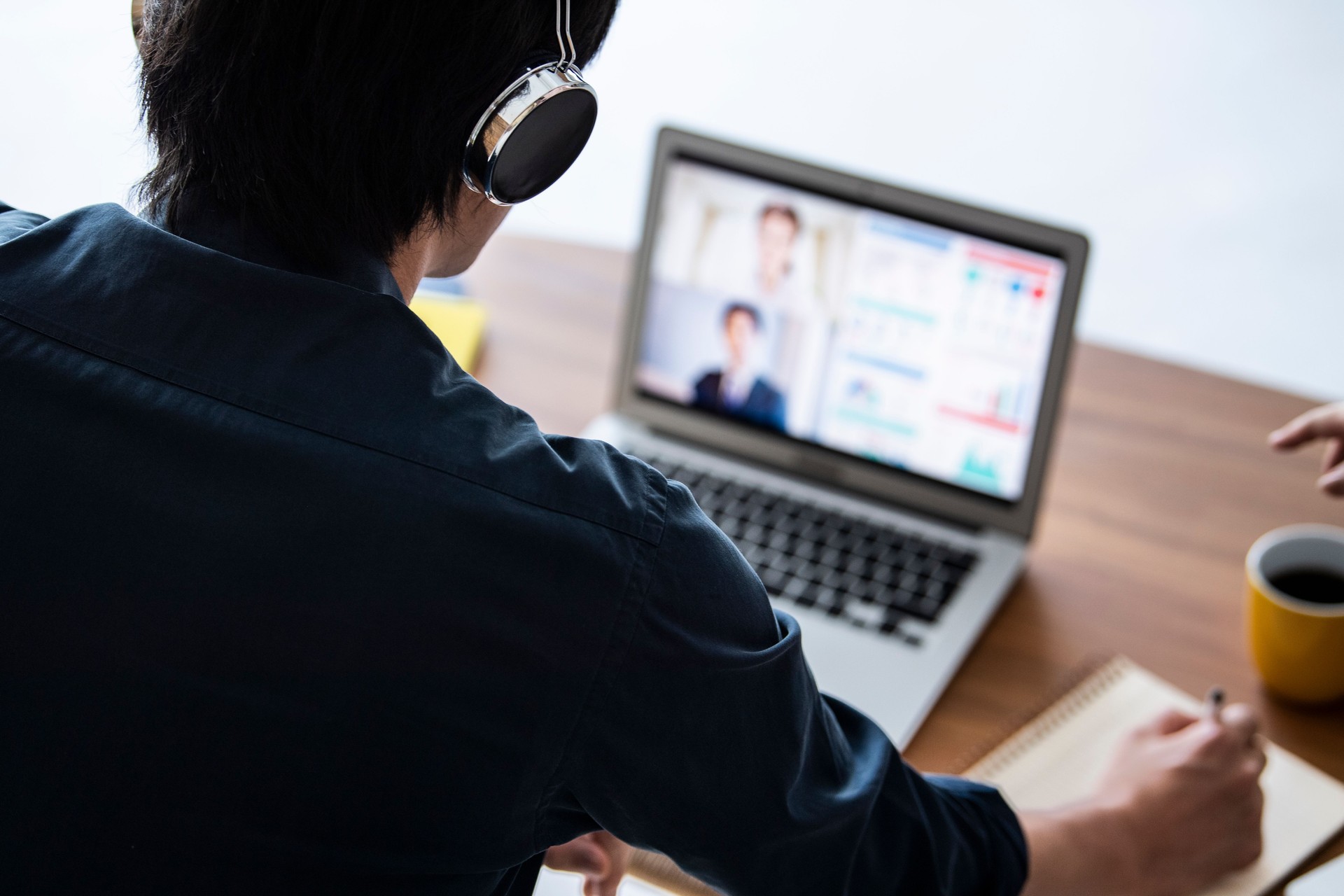 A businessman is having an online meeting with a client
